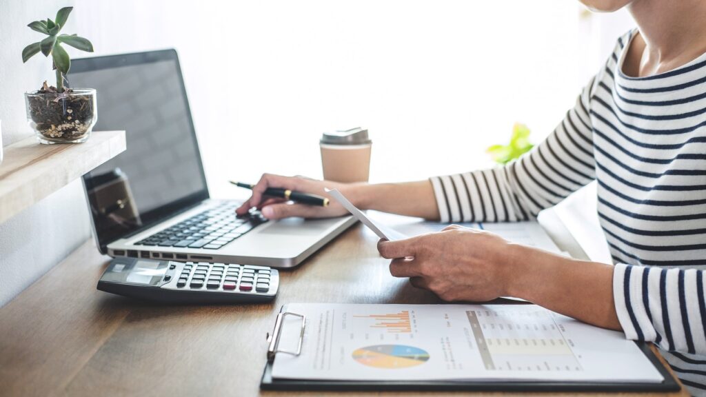 Reviewing financial charts at a laptop