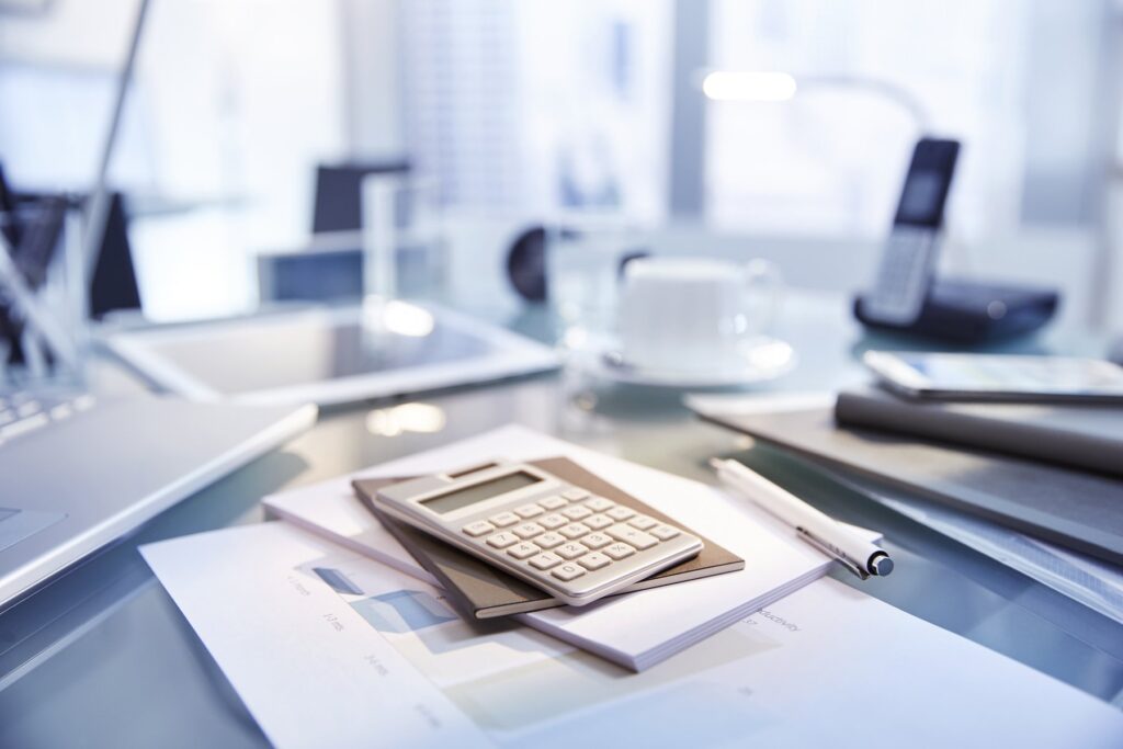 Desk with laptop and financial paperwork